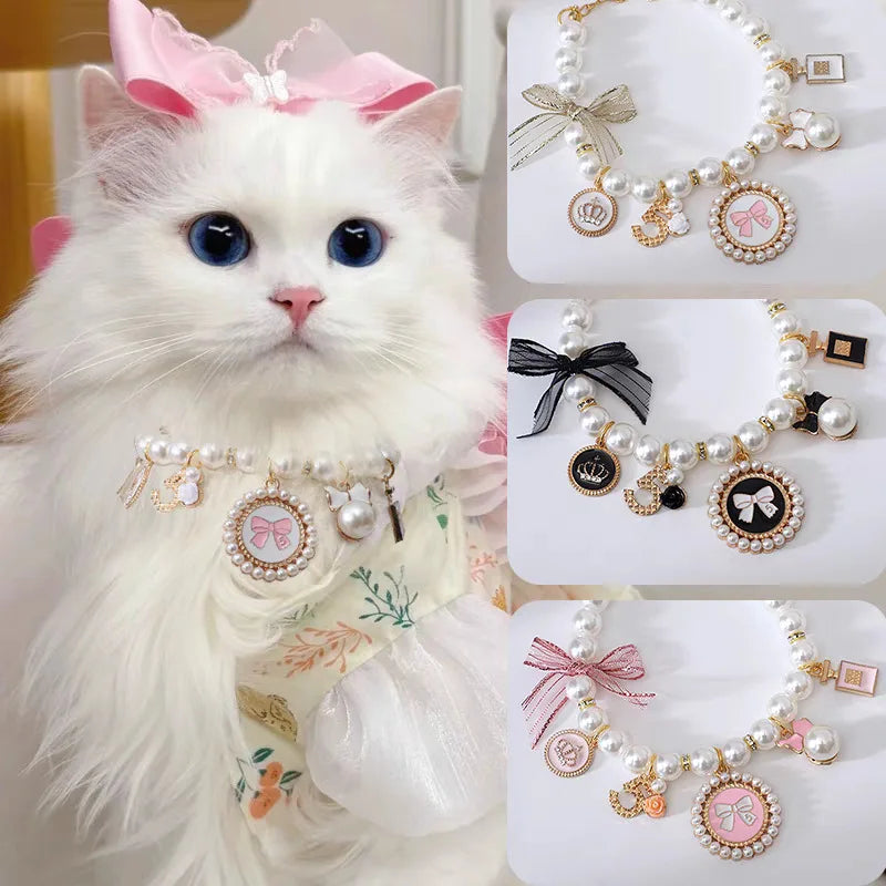 Cat wearing pearl pet collar with lace bow and pink-accent charms, white beads