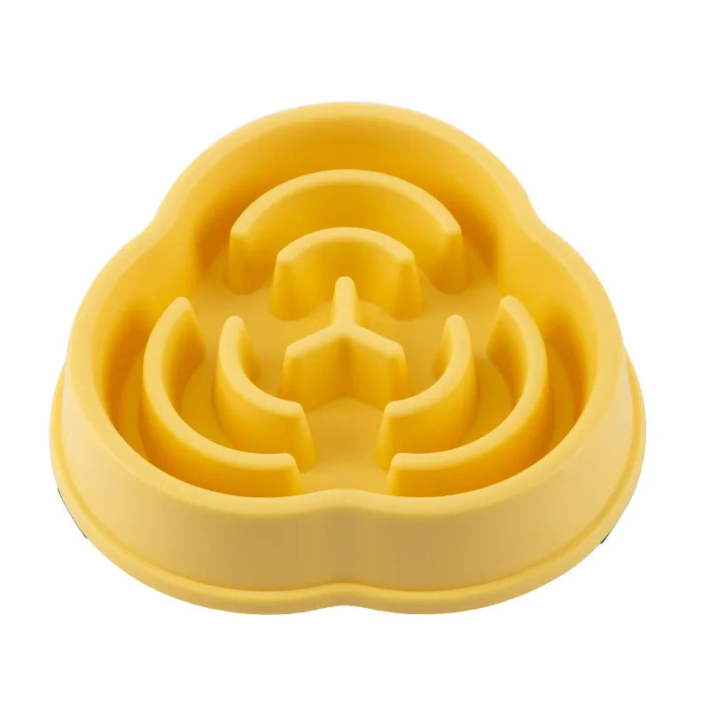Yellow slow feeder pet bowl, top view of raised maze and rounded pegs inside