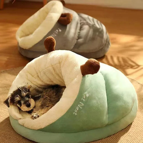 Light green dog bed mattress cushion with plush hood, dog sleeping inside.