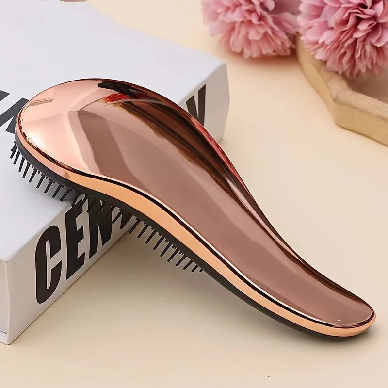 Rose-gold shedding rake comb with black teeth, curved profile and tapered handle