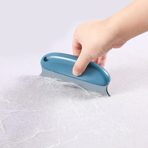 Pet deshedding brush with blue handle and black comb teeth on thick fur