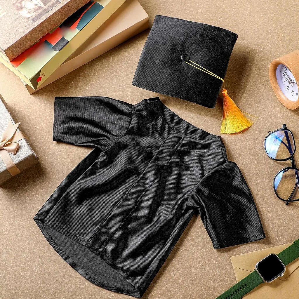 Black graduation costume robe with matching mortarboard hat and yellow tassel