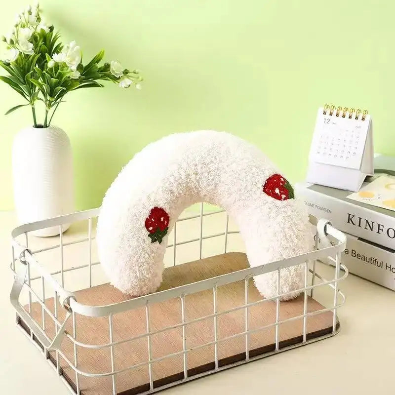 White U-shaped plush pet pillow with red strawberry embroidery