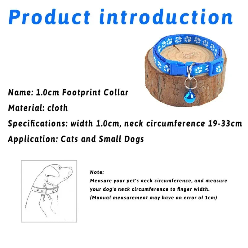 Blue paw print cat collar with bow and bell, shown on a small log