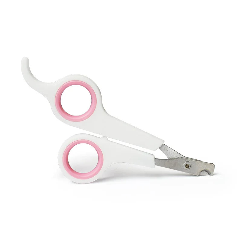 Pet nail trimmer scissors with pink rings, white handles and metal cutting blades