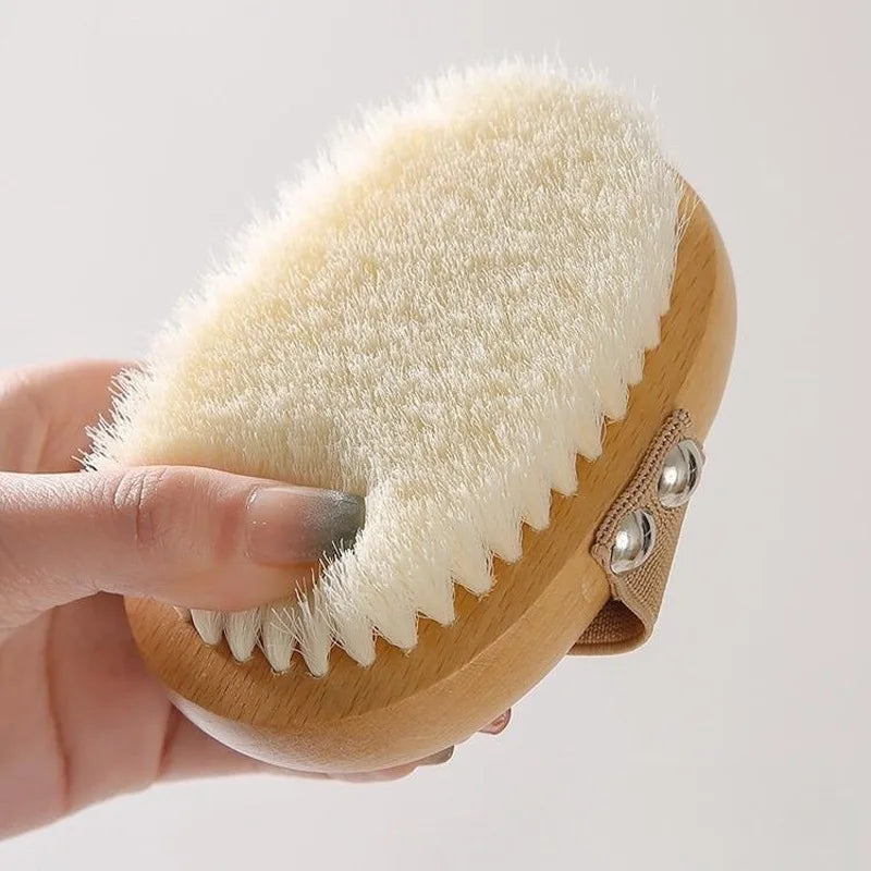 Pet bath brush head in hand, beige bristles on wood ring with white edge and nubs