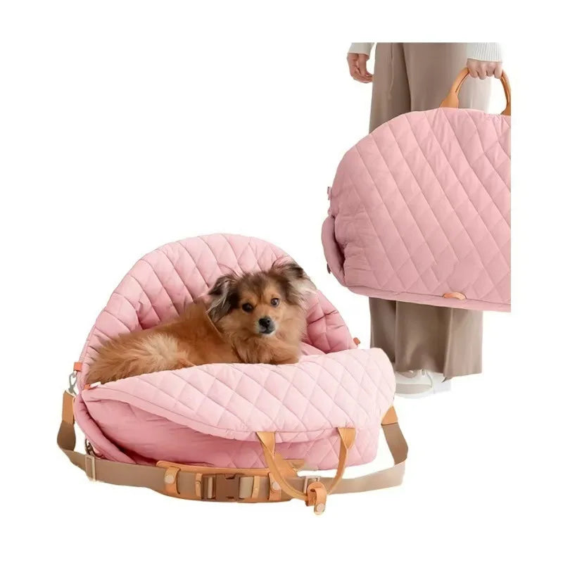 Pink quilted dog car seat carrier bed with safety straps and tan buckles