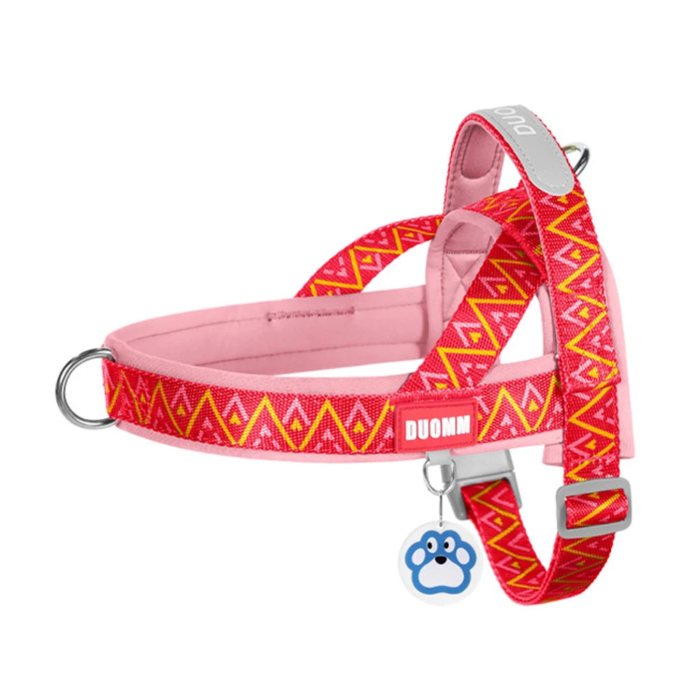 Pink no-pull padded dog harness vest with red geometric pattern and D-ring hardware.