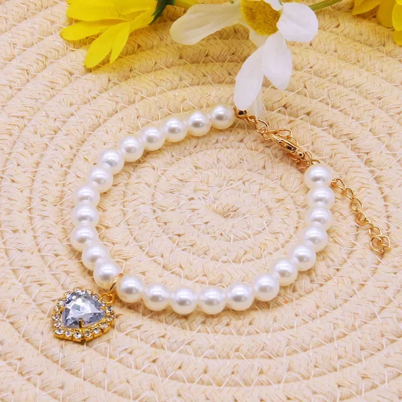 Pet white pearl necklace collar with round clear crystal pendant on gold chain.