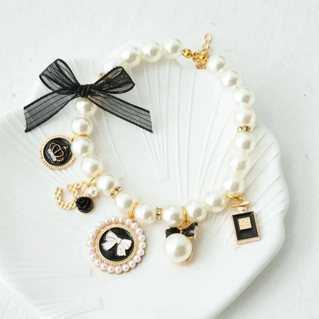 Pearl pet collar with black lace bow and circular charm medallion, white beads