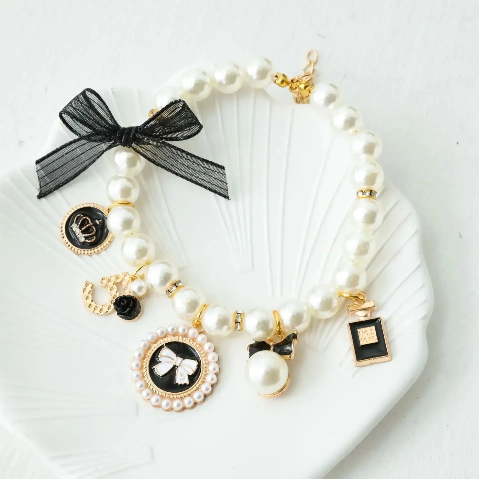 Pearl pet collar with black lace bow and circular charm medallion, white beads