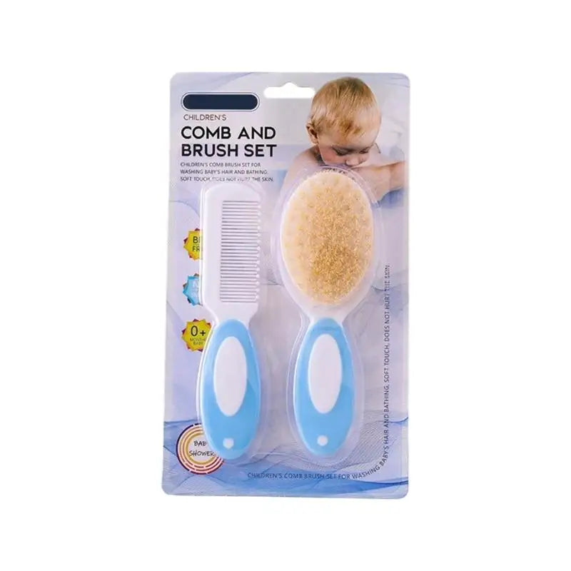 Infant comb and brush set with blue handles, white comb, and tan oval brush pad