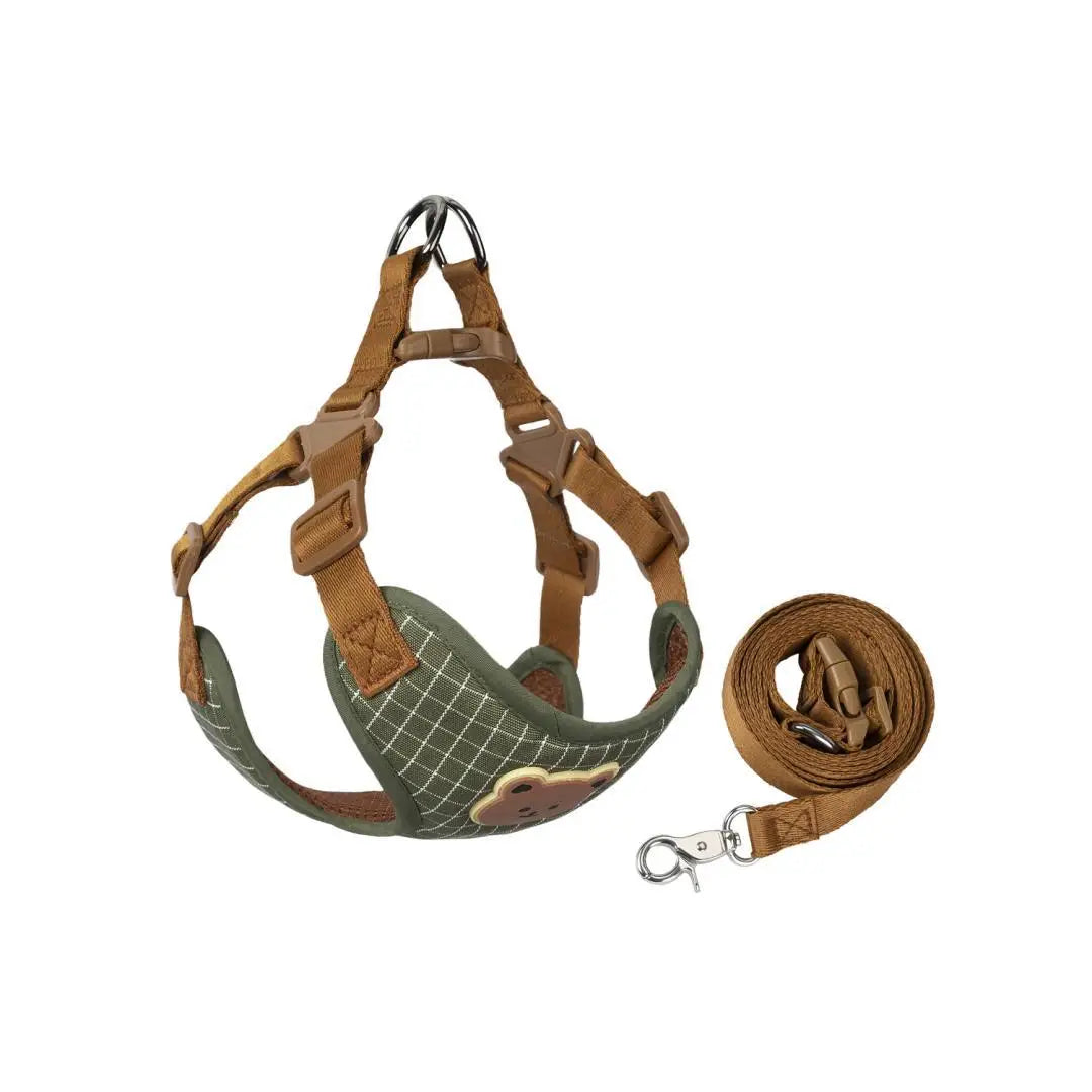 Plaid green dog harness with brown straps and matching leash, folded for viewing