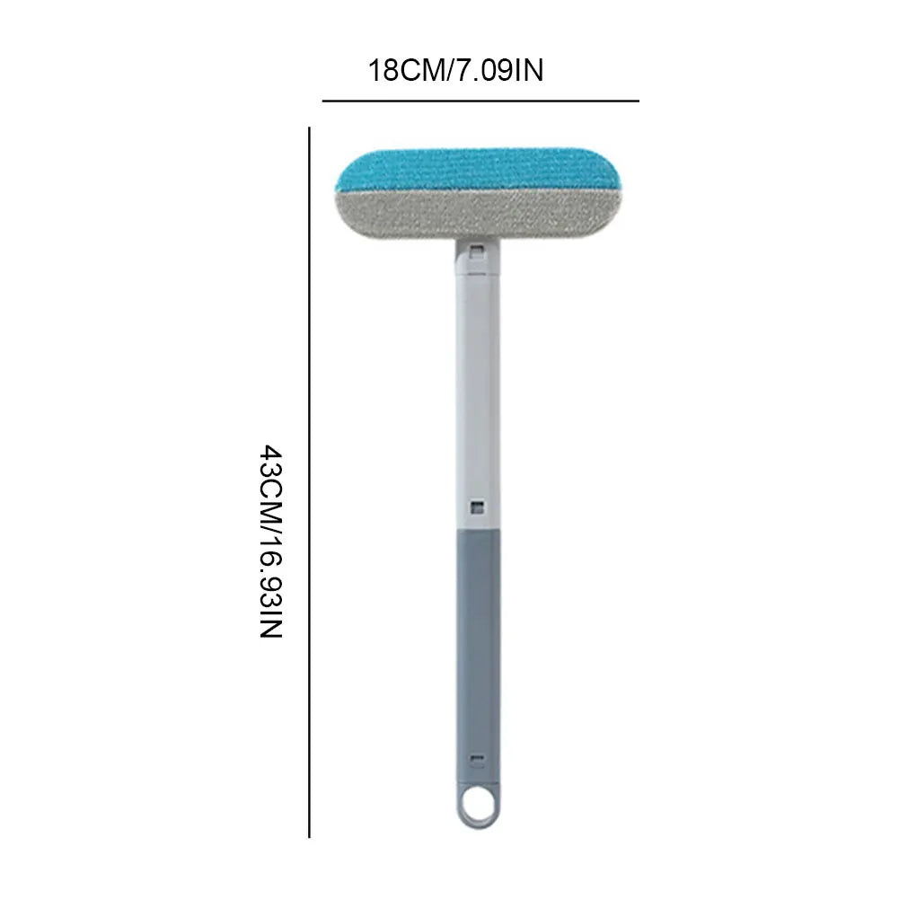 Long-handled pet hair remover brush with blue-gray cleaning pad on white handle