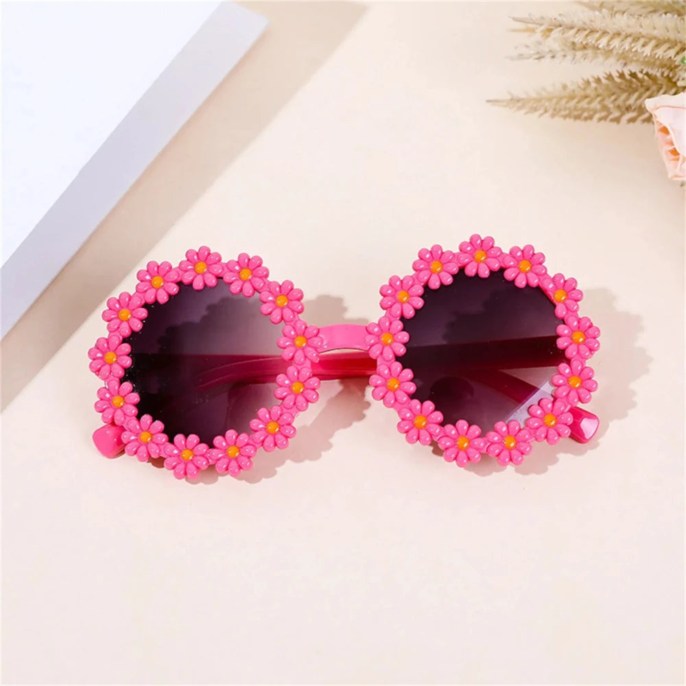 Pink daisy flower sunglasses with dark lenses and bright pink flower trim