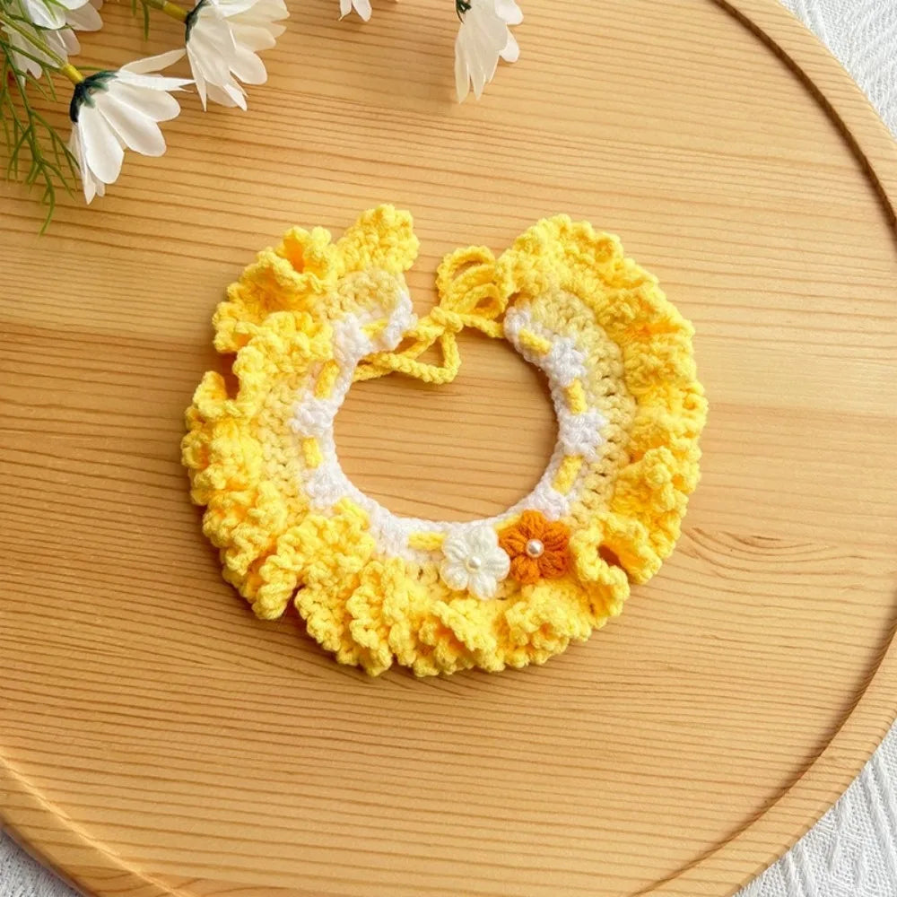 Yellow crocheted pet scarf bib with loop ties and white flower trim