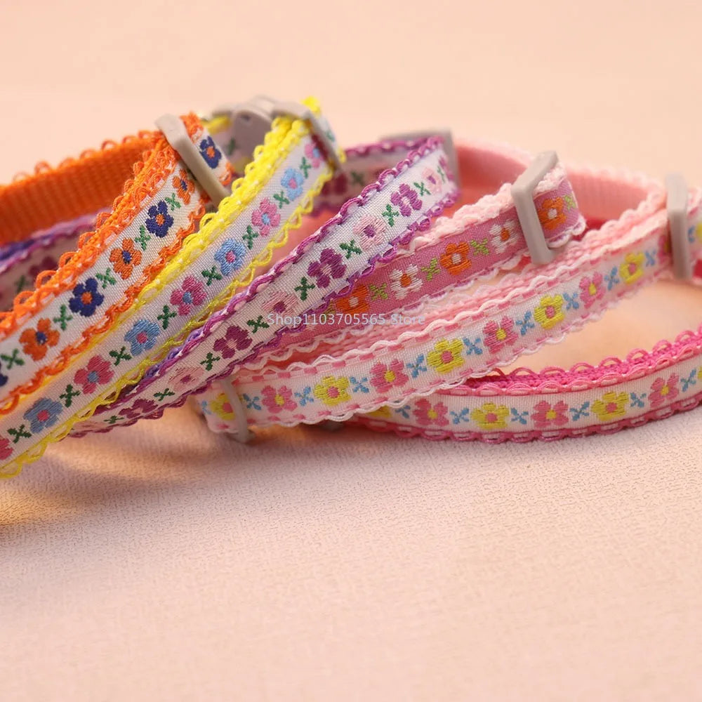 Floral embroidered lace cat collar, pink-and-blue floral ribbon with silver buckle clasp.