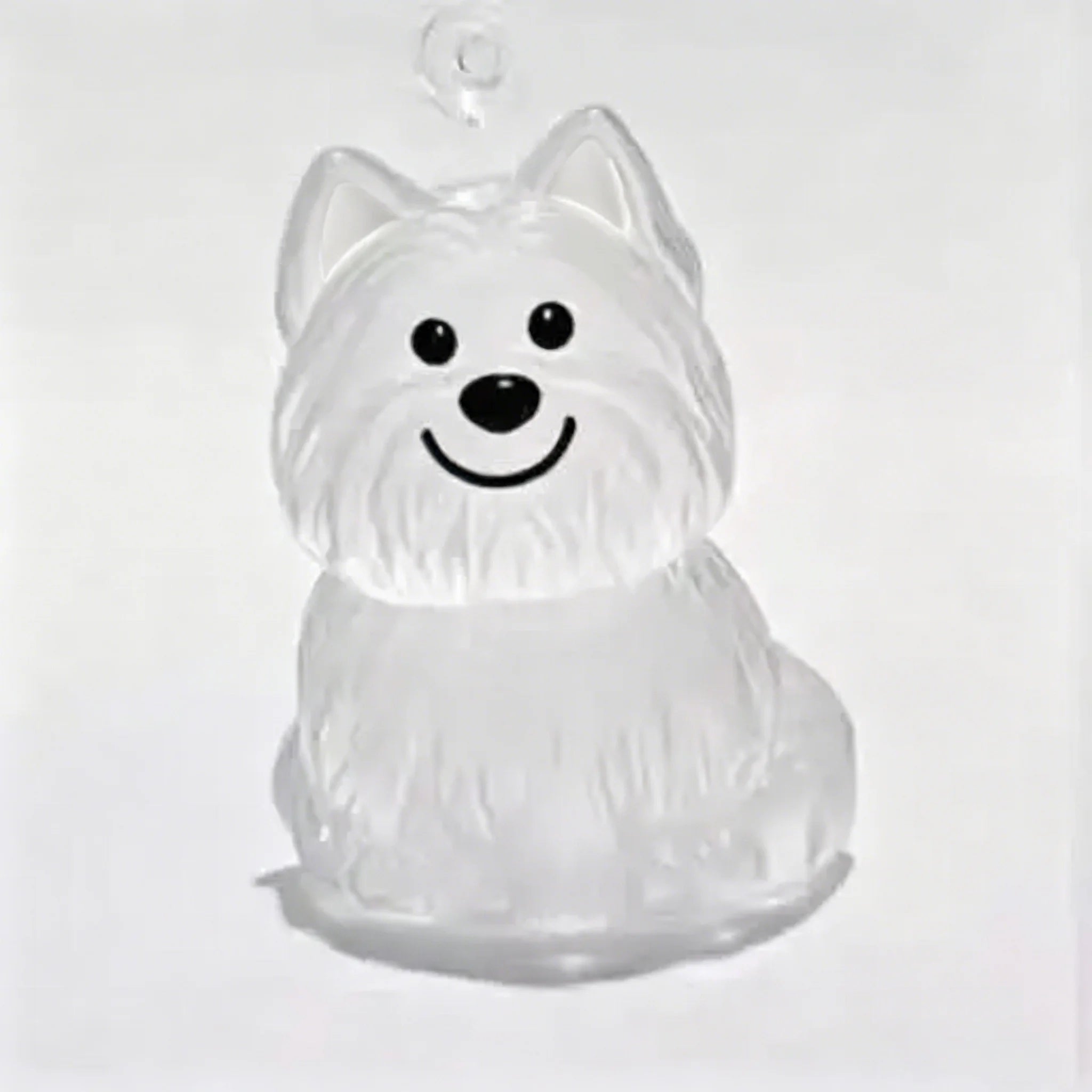 Clear dog-shaped resin capsule keychain with black face