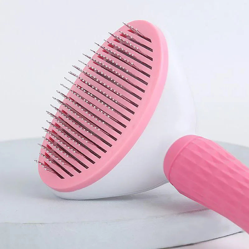 Pink dog grooming brush with pin comb head and rounded handle