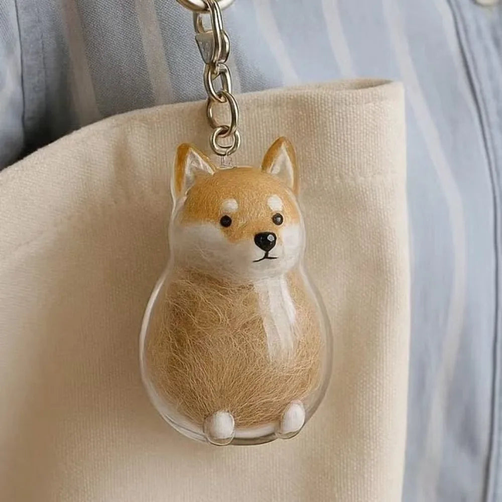 Transparent pet hair memorial keychain capsule with brown-and-white dog figurine