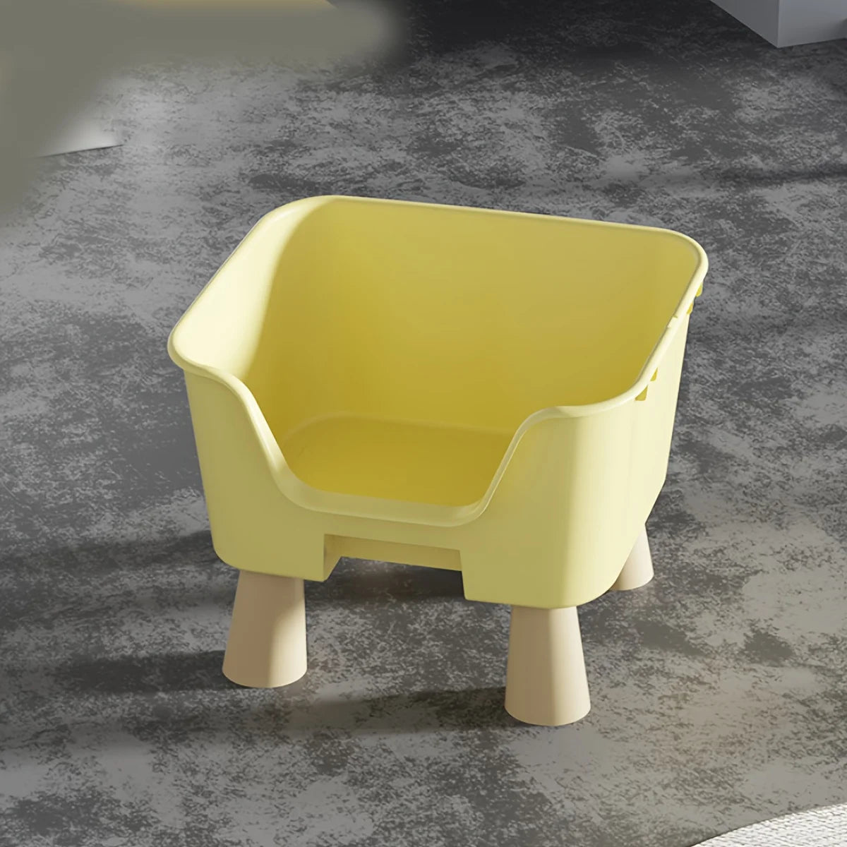 Yellow cat bed with raised legs and curved front opening, molded interior basin.