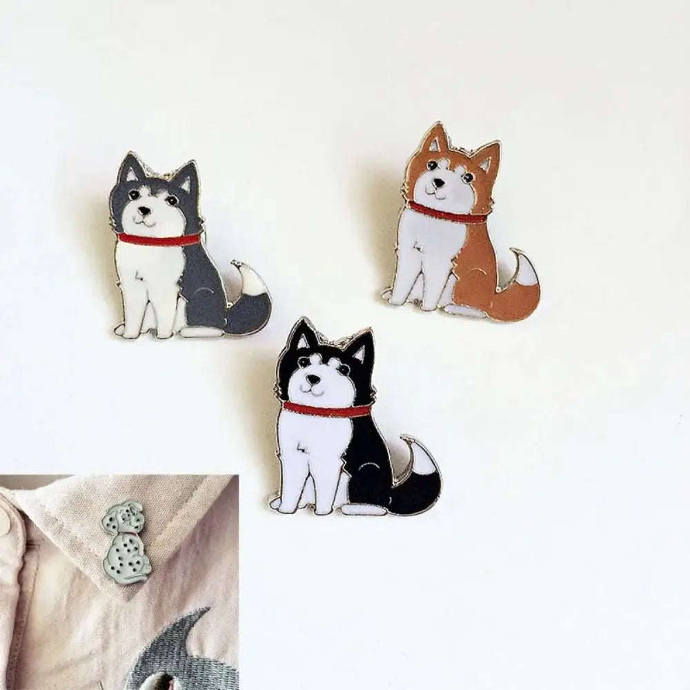 Cartoon husky and corgi enamel pins in black, white, and brown with red collar