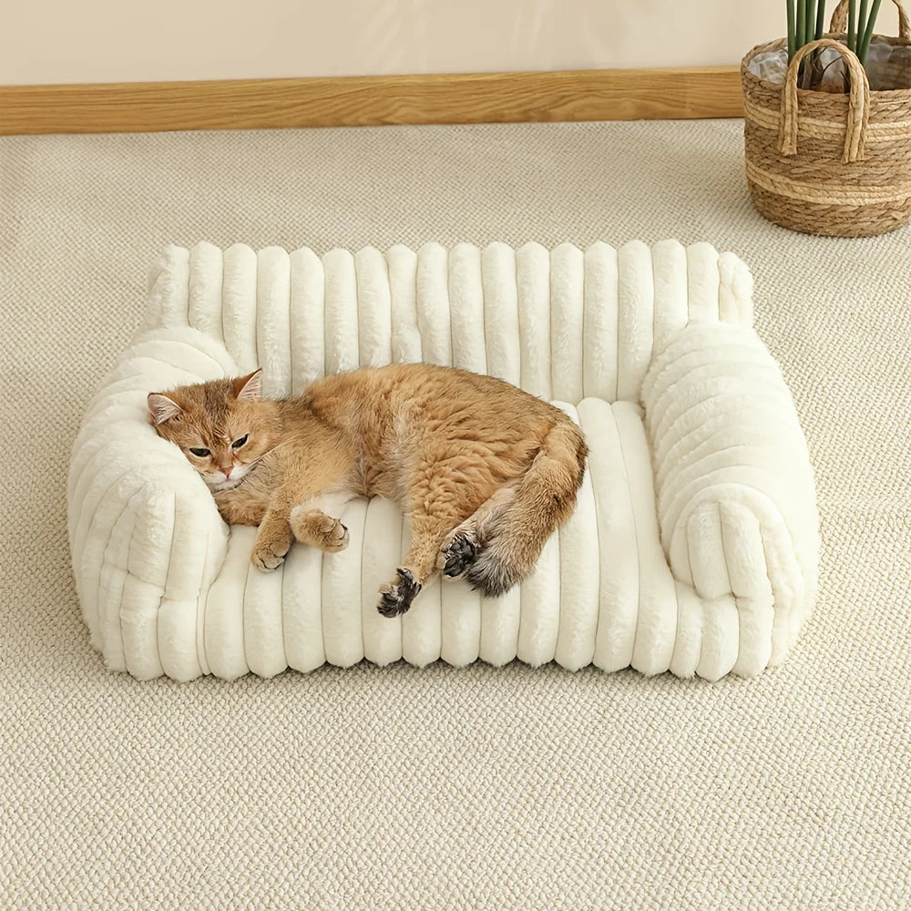 Cream ribbed cat sofa bed with thick bolsters; orange cat lying inside