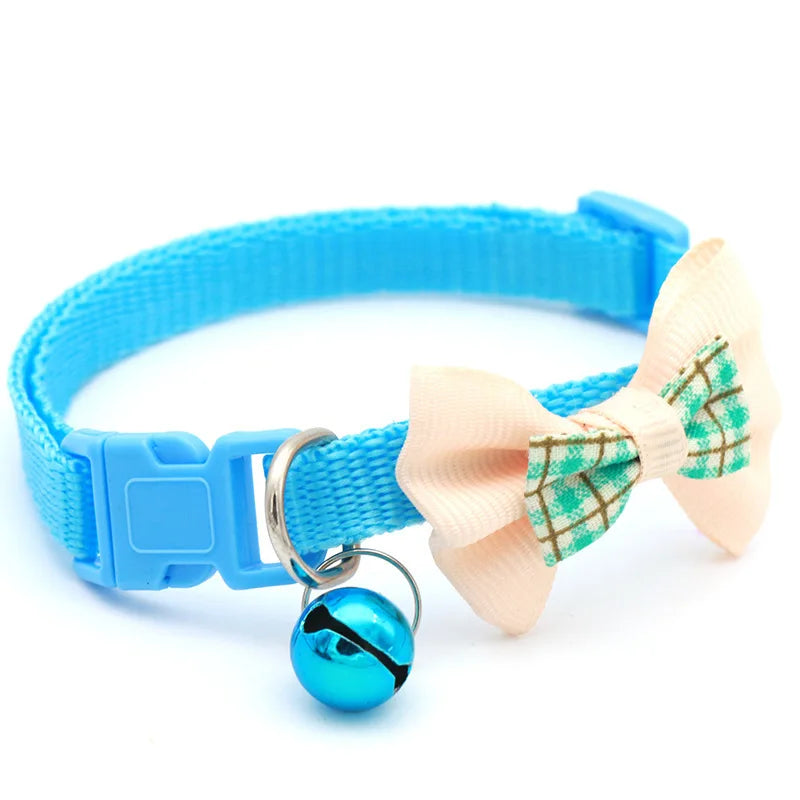 Blue cat collar with white bow tie and round teal bell