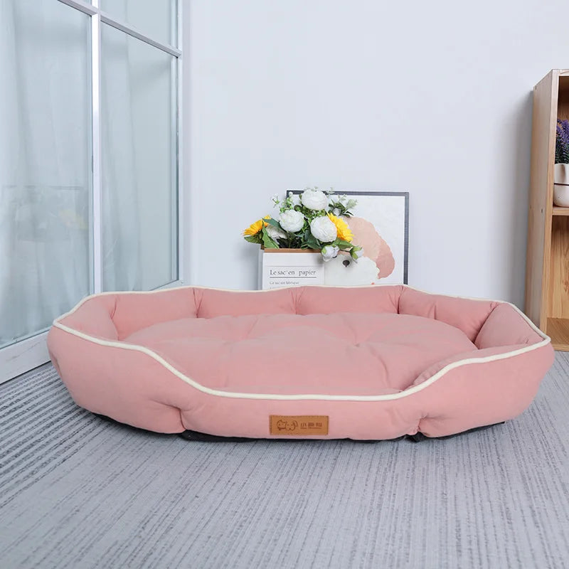 Large plush sofa bed for pets, pink cushion with light edging and padded bolsters