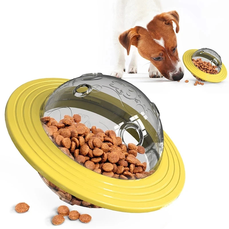 Yellow and gray treat puzzle toy with clear dome, filled with brown kibble