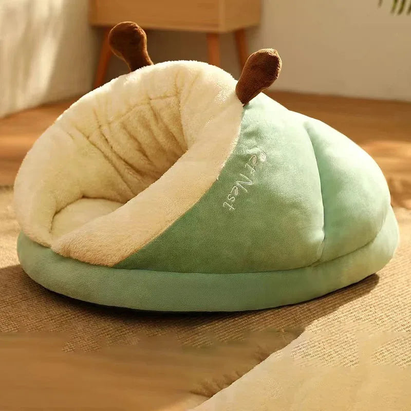 Light green dog bed mattress cushion with plush hood and resting dog inside.