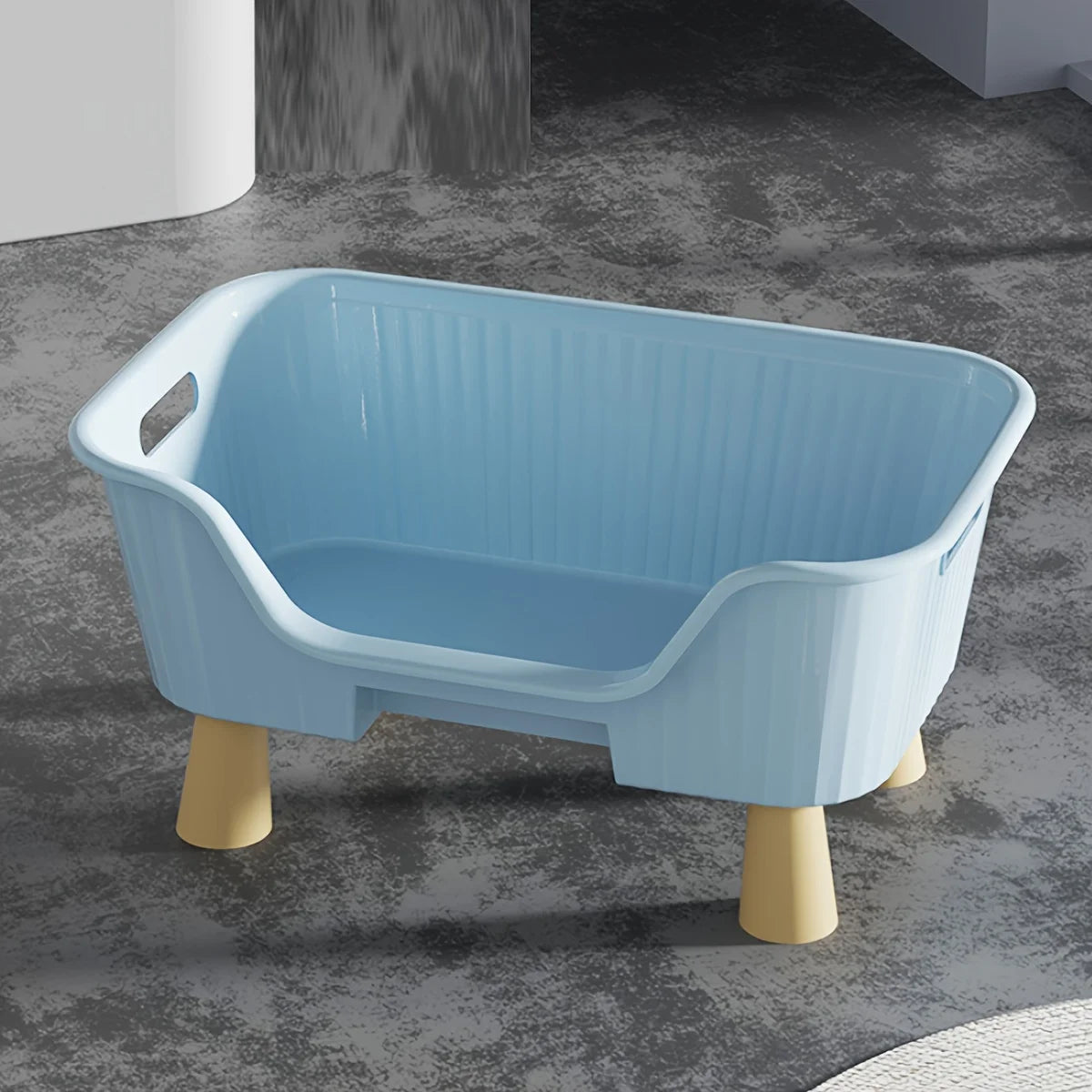 Blue cat bed with white frame, raised legs and curved front opening, molded interior.