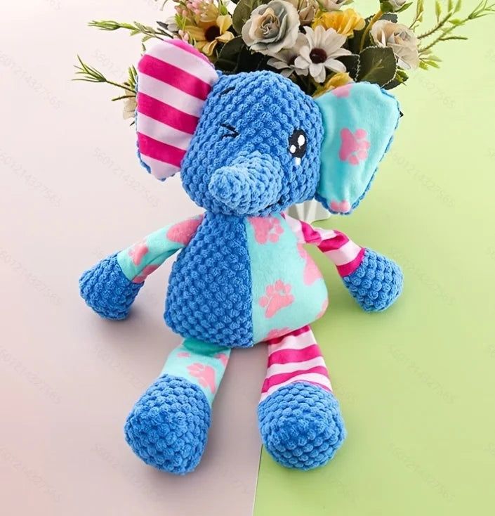 Blue elephant plush squeaky toy with pink paw-pattern outfit and striped tail