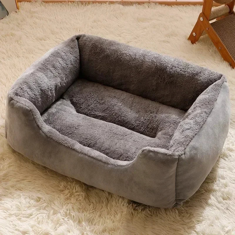 Gray pet bed with thick bolstered sides and an empty plush interior