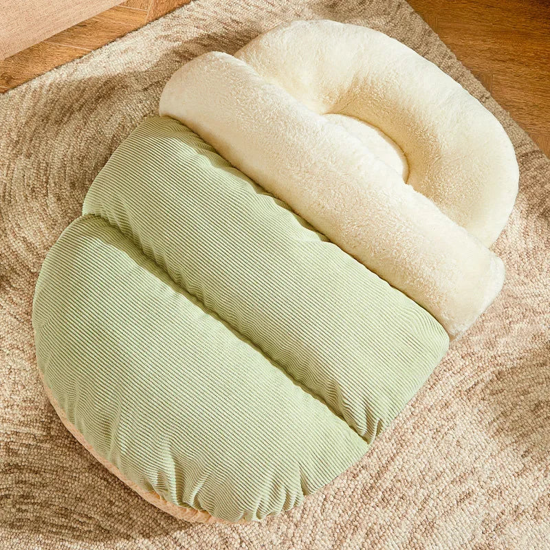 Enclosed cat bed with cream nest and green cushioned bolster