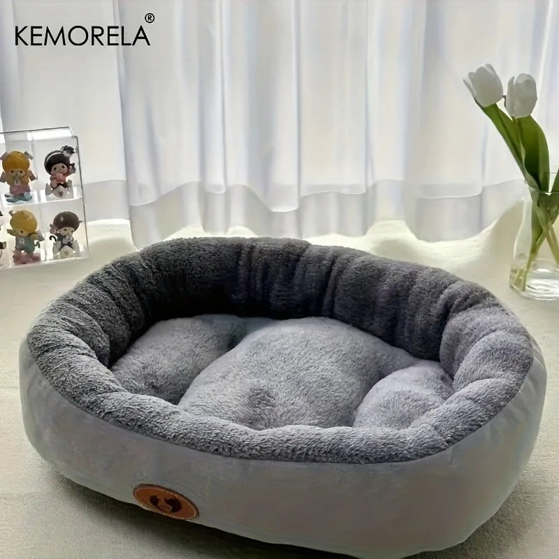 Dark gray plush oval pet bed with cream inner cushion and paw logo patch