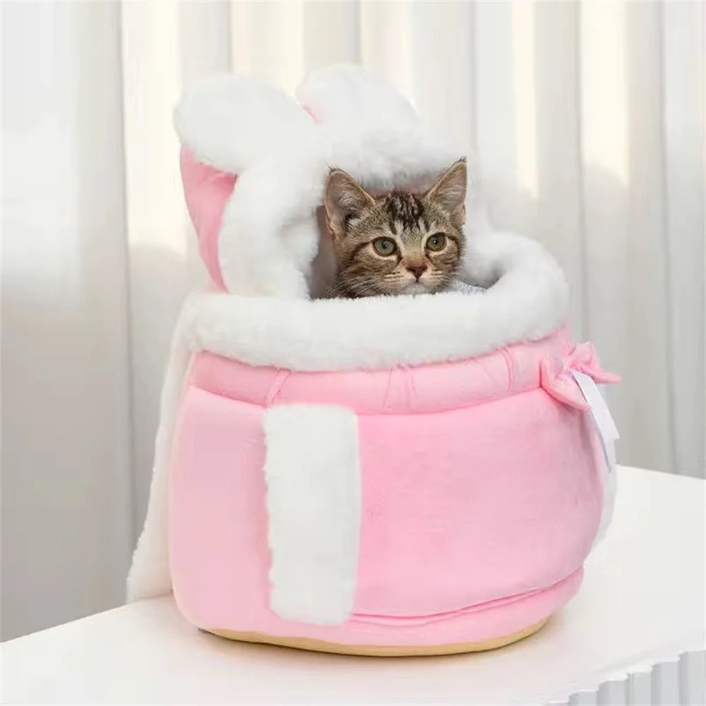 Pink small pet carrier backpack with white faux-fur hood and padded side panels