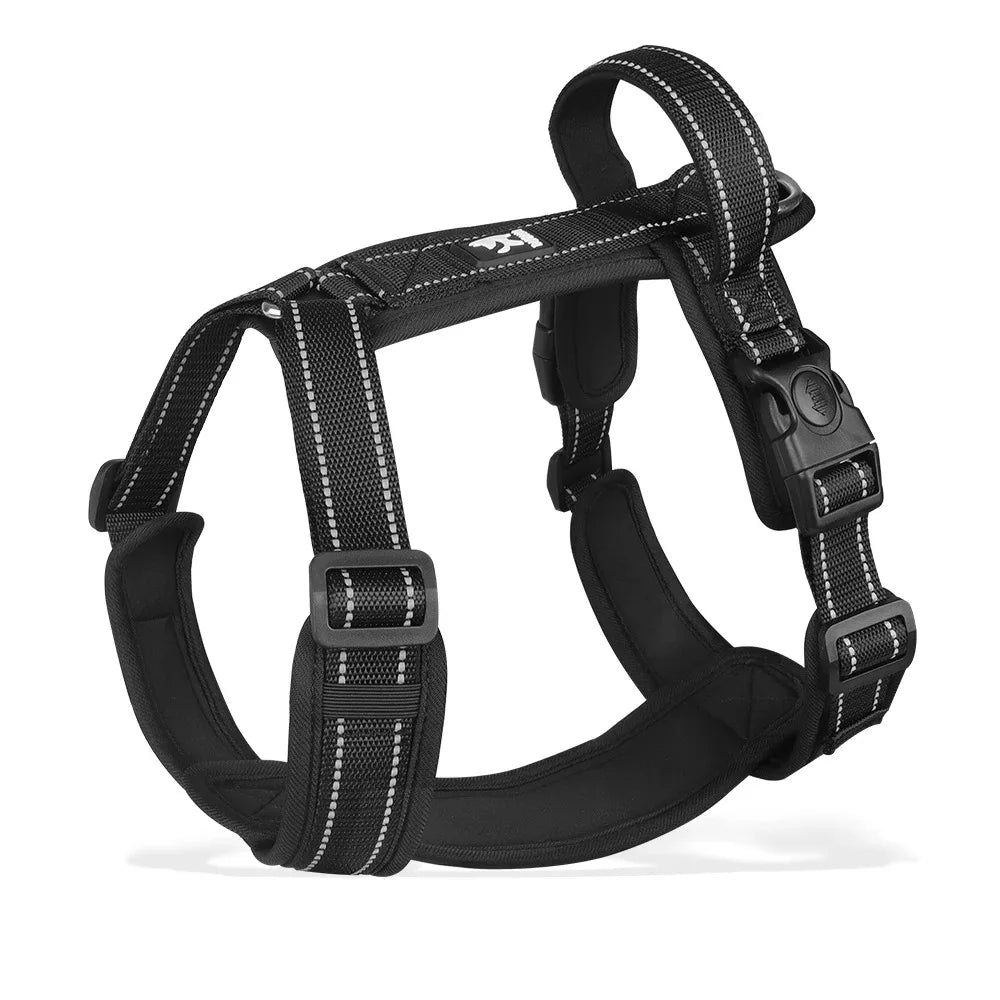Black dog harness with reflective-style white stitching, padded chest support, metal ring