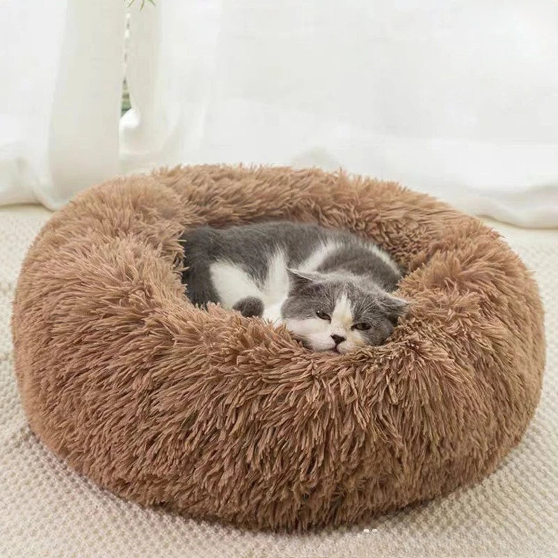 Round faux fur plush pet bed in tea brown with cats curled inside