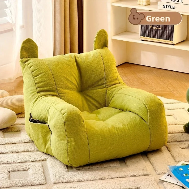 Green cartoon cat sofa bed with detachable cushions, empty seat on rug