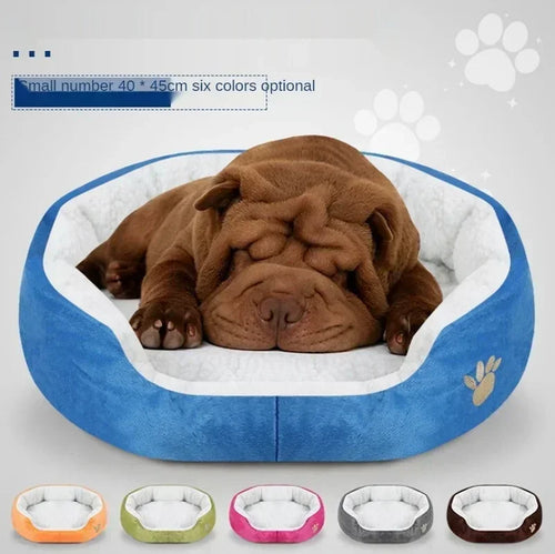Plush oval dog bed, dark brown outer cover with white cushioned center and paw emblem