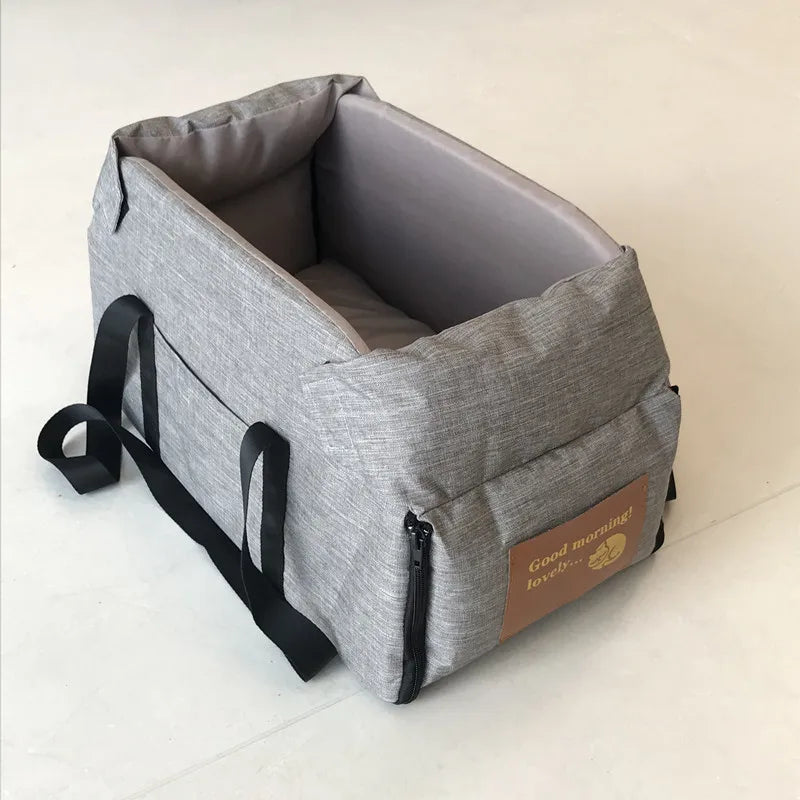 Grey waterproof dog car seat carrier with side straps and front zipper; empty