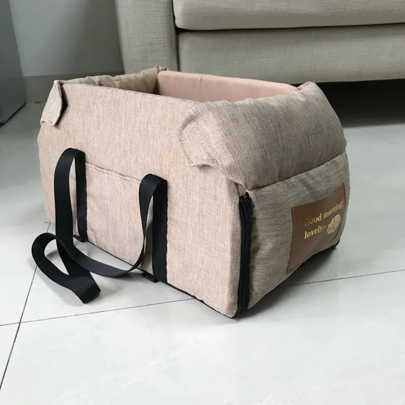 Light khaki dog car seat bed with side handles and shoulder strap, soft padded interior
