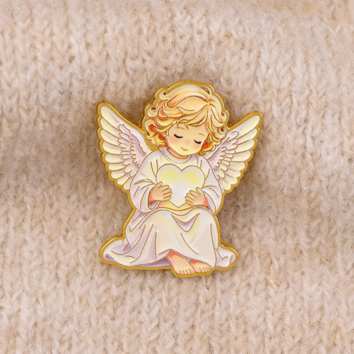 White angel enamel pin with wings and hands folded over its chest