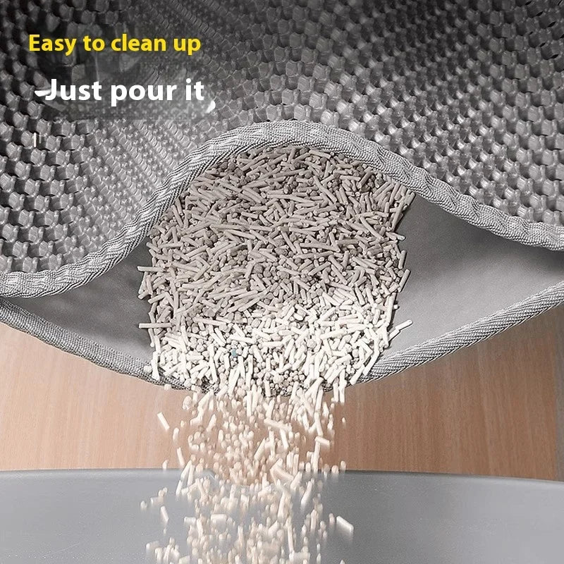 Gray cat litter mat with raised honeycomb texture, litter pouring into top layer