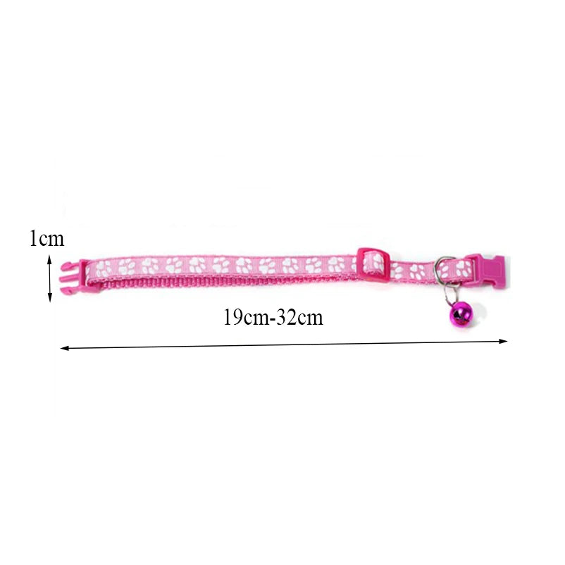 Pink paw print cat collar with bow and bell, shown laid flat with size line