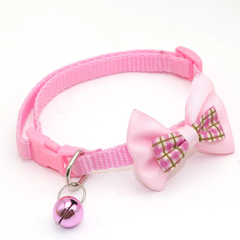 Pink cat collar with paw-print bow tie and round bell charm
