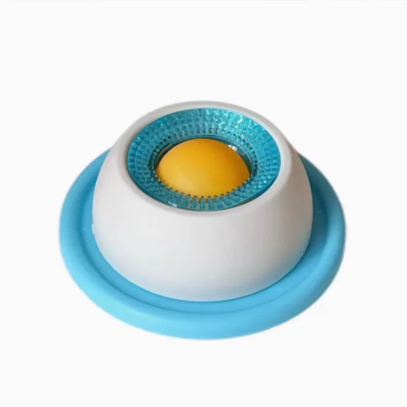 Pet licking puzzle toy with blue base and white dome, teal textured rim, orange insert