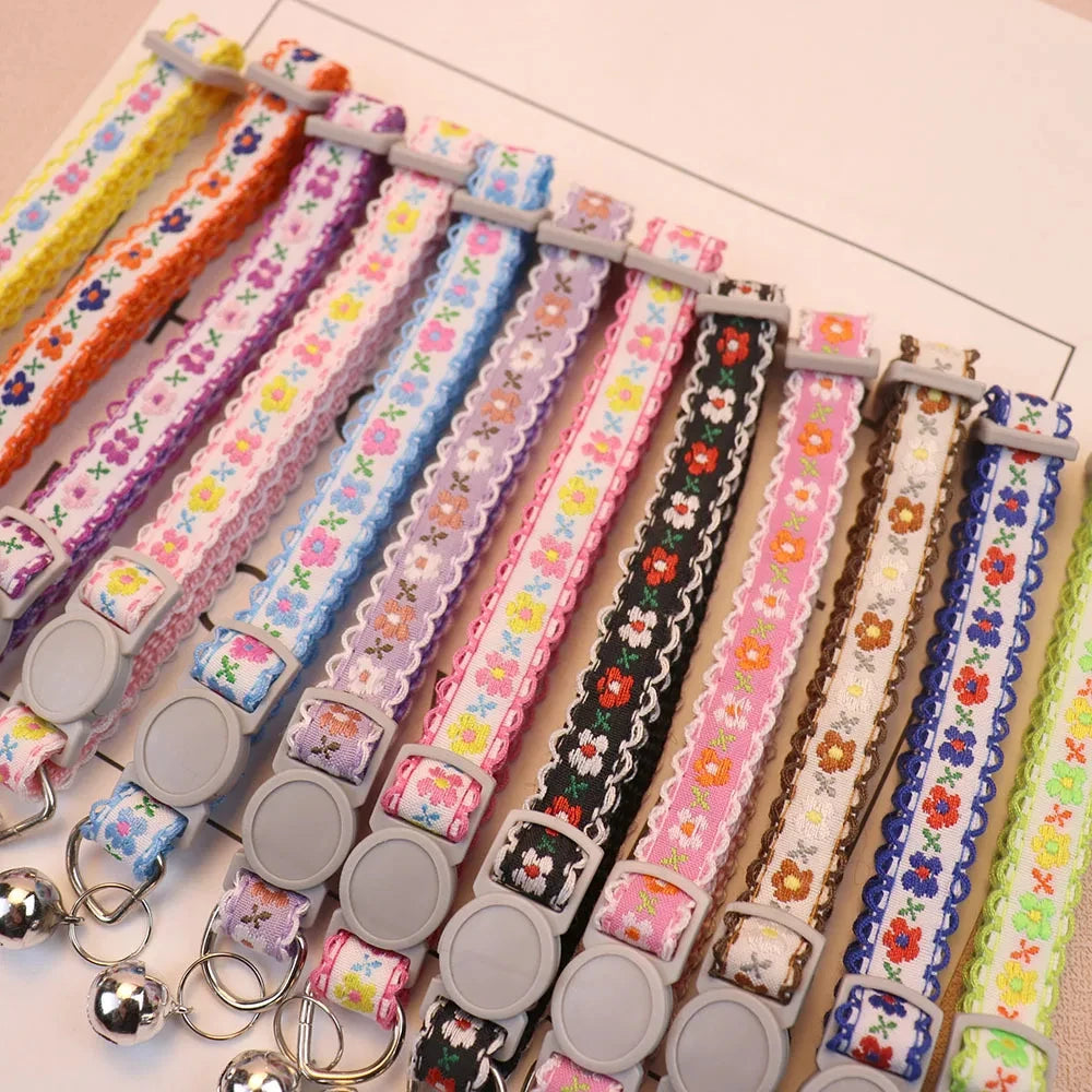 Floral lace cat collar with bell, assorted colors on display with buckles and rings