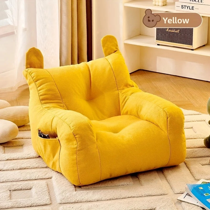 Yellow cartoon cat sofa bed with detachable cushion design, empty seat on rug